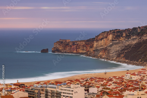 Long exposure shot of the city of Nazaré, the beach, cliffs and the fort of São Miguel Arcanjo photo