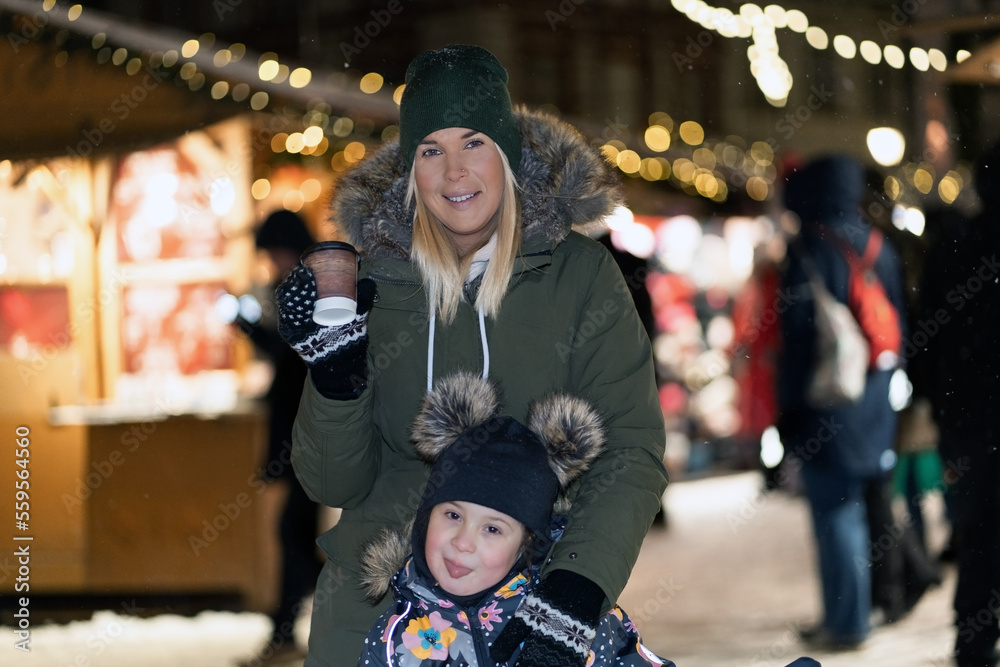 Mother and daughter at the Christmas market in the old town of Tallinn. Mother and daughter at the Christmas market in the old town of Tallinn.
