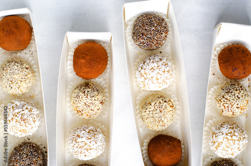 Assorted vegan sweets, Delicious Candy Balls with seeds, dried fruit and cocoa powder, Healthy Candies Assorted vegan sweets, Delicious Candy Balls with seeds, dried fruit and cocoa powder, Healthy Candies
