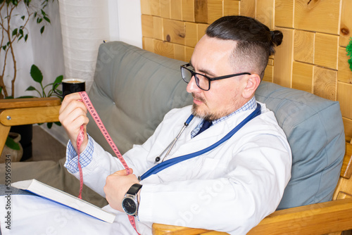 Ταπετσαρία General practitioner or nutritionist holds measuring tape in his hands as he pre