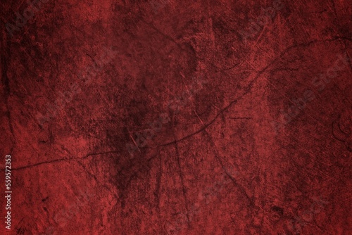 A textured background featuring deep red tones with a distressed, grunge appearance. The surface shows scratches and uneven patterns, creating a vintage feel.
