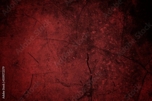 A textured background featuring deep red tones with a distressed, grunge appearance. The surface shows scratches and uneven patterns, creating a vintage feel.