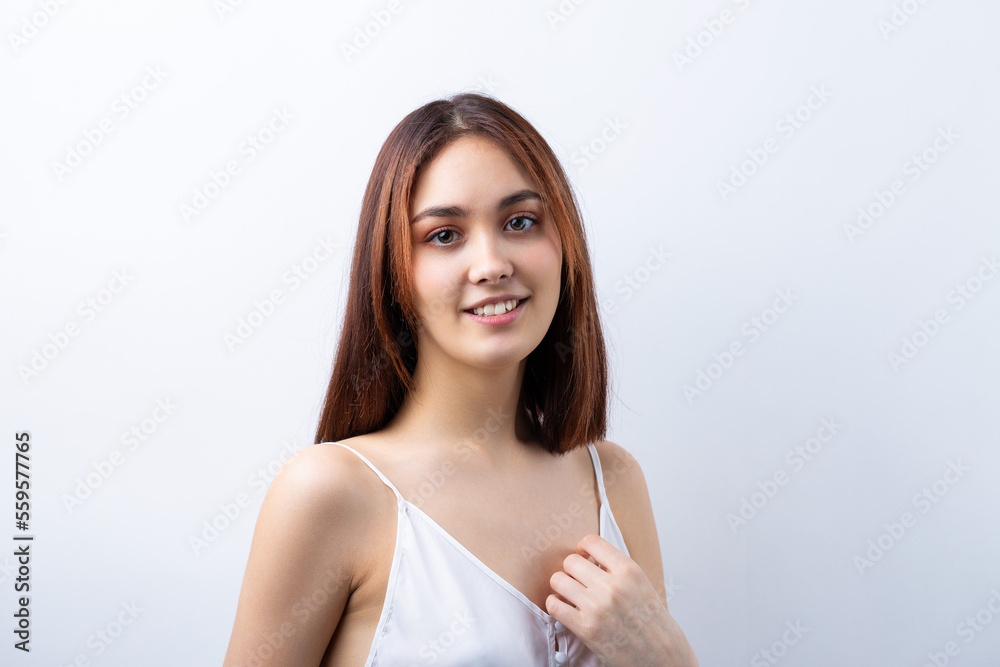 Beautiful smiling woman with clean skin, natural make-up and white teeth on a gray background Beautiful smiling woman with clean skin, natural make-up and white teeth on a gray background