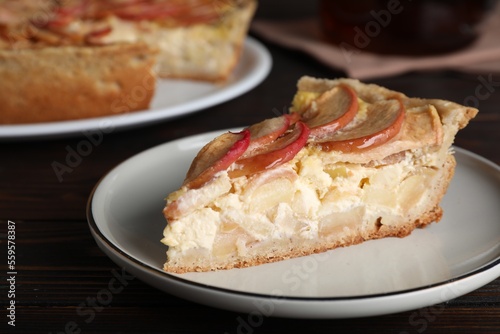 Piece of delicious homemade apple pie on wooden table, closeup