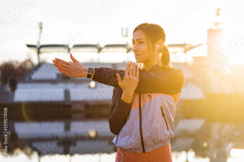 Fitness woman doing stretching exercise outdoor in a urban environment. Healthy lifestyle