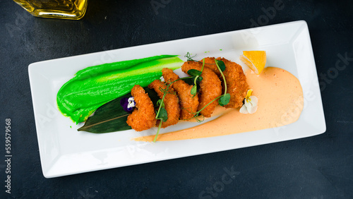 Asian food tempura shrimp fried breaded with lemon and sauces.