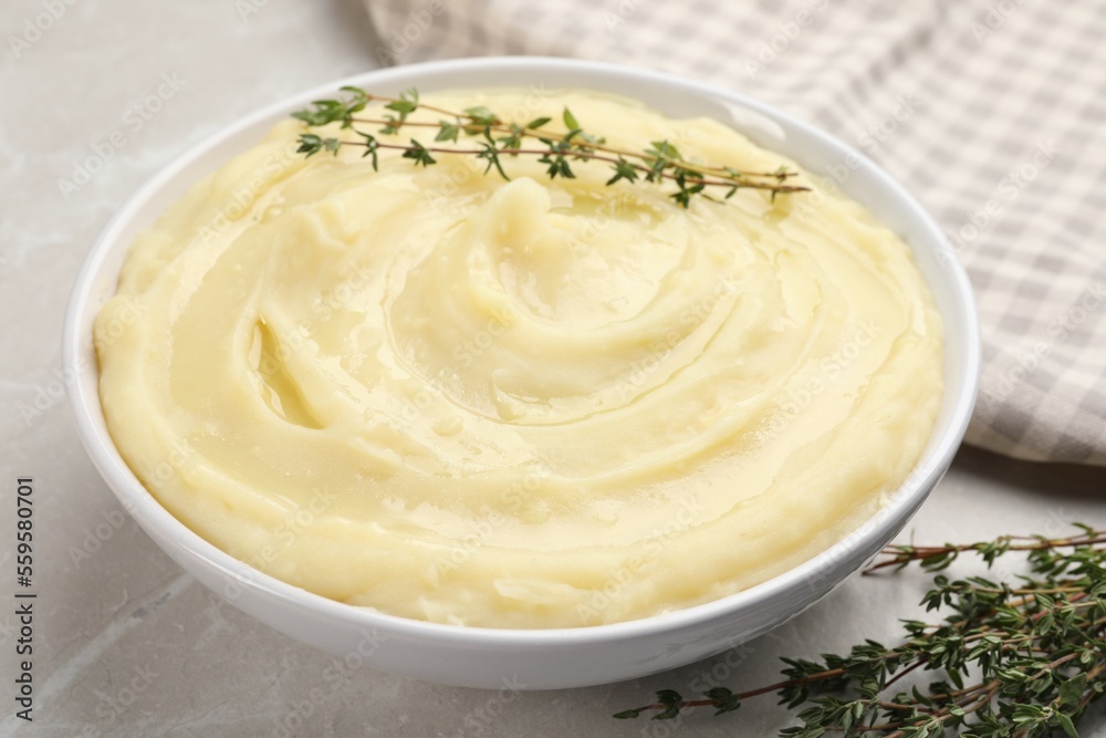 Bowl of tasty mashed potato with rosemary on grey marble table, closeup Bowl of tasty mashed potato with rosemary on grey marble table, closeup