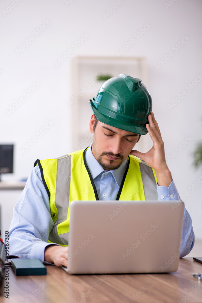 Young male architect working in the office Young male architect working in the office