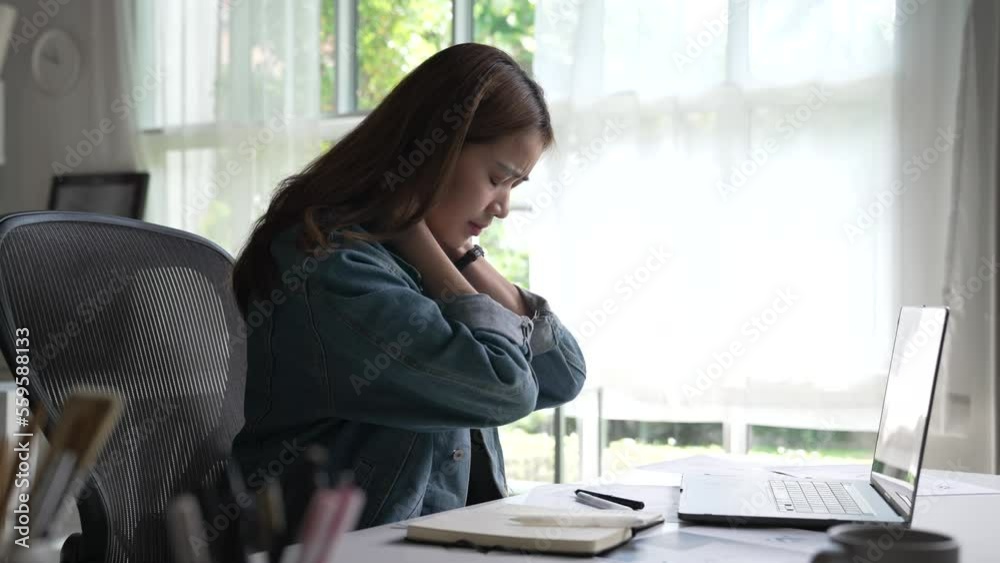 Young Asian business woman suffering from neck pain while working. Office syndrome concept. Young Asian business woman suffering from neck pain while working. Office syndrome concept.