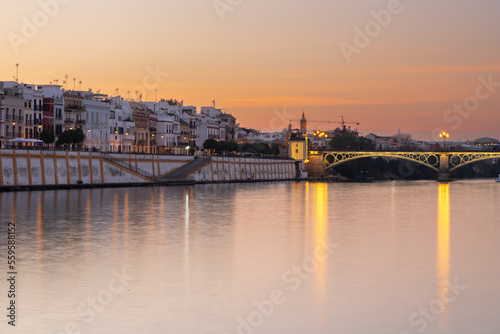 Sunset over the authentic neighborhood of Tirana in Seville with views on Calle Betis, Torre Sevilla and with awesome reflections in the river Guadalquivir, creating magic atmosphere and views © KimWillems
