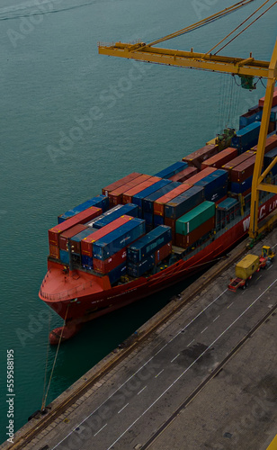 Container ship in industrial port in import, export trade logistic and international transportation by container ship in open sea.