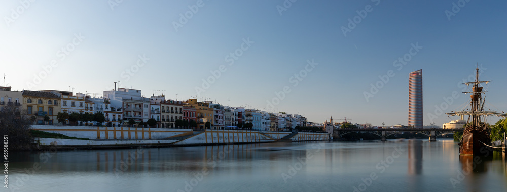 Sunset over the authentic neighborhood of Tirana in Seville with views on Calle Betis, Torre Sevilla and with awesome reflections in the river Guadalquivir, creating magic atmosphere and views Sunset over the authentic neighborhood of Tirana in Seville with views on Calle Betis, Torre Sevilla and with awesome reflections in the river Guadalquivir, creating magic atmosphere and views