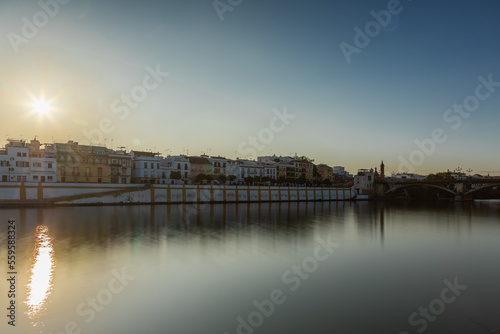 Sunset over the authentic neighborhood of Tirana in Seville with views on Calle Betis, Torre Sevilla and with awesome reflections in the river Guadalquivir, creating magic atmosphere and views © KimWillems