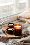  warm cozy window arrangement, winter or autumn concept, candles throw lights