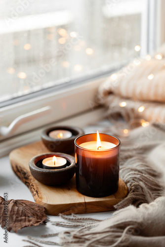  warm cozy window arrangement, winter or autumn concept, candles throw lights