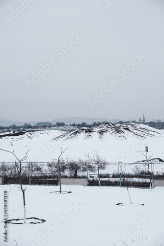 Lost park urban landscape landfill covered by snow during cold winter in Montreal Quebec © Selena