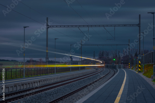 NIght dark color train lines in night between Prague and Tabor towns in Czech