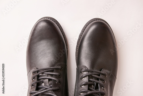 Black leather men's boots on a white background. Warm shoes for winter.