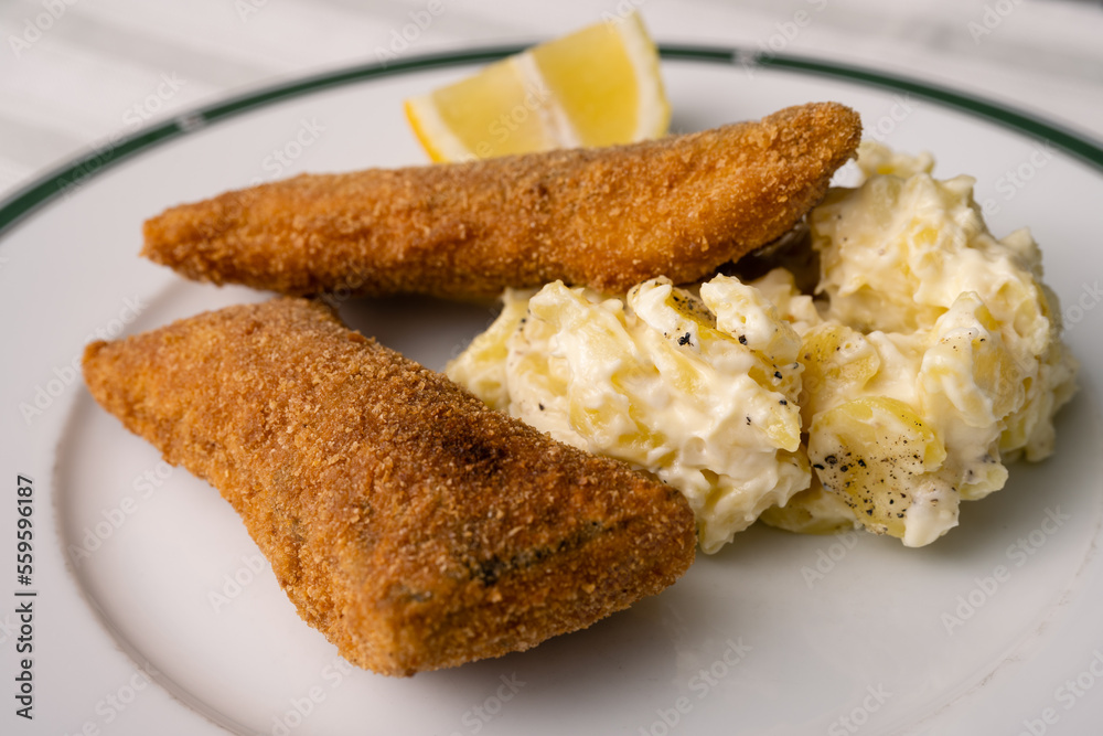 Breaded and Fried Carp Fillet with Mayonnaise Potatoe Salad and Lemon, a Traditional Christmas Dish in Bohemia and Austria Breaded and Fried Carp Fillet with Mayonnaise Potatoe Salad and Lemon, a Traditional Christmas Dish in Bohemia and Austria