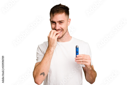 Young caucasian man holding a vaporizer cut out isolated biting fingernails, nervous and very anxious.