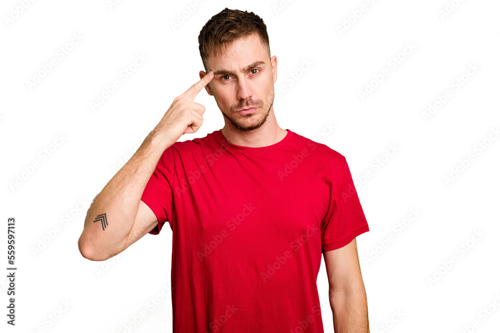 Young caucasian man cut out isolated pointing temple with finger, thinking, focused on a task. Young caucasian man cut out isolated pointing temple with finger, thinking, focused on a task.