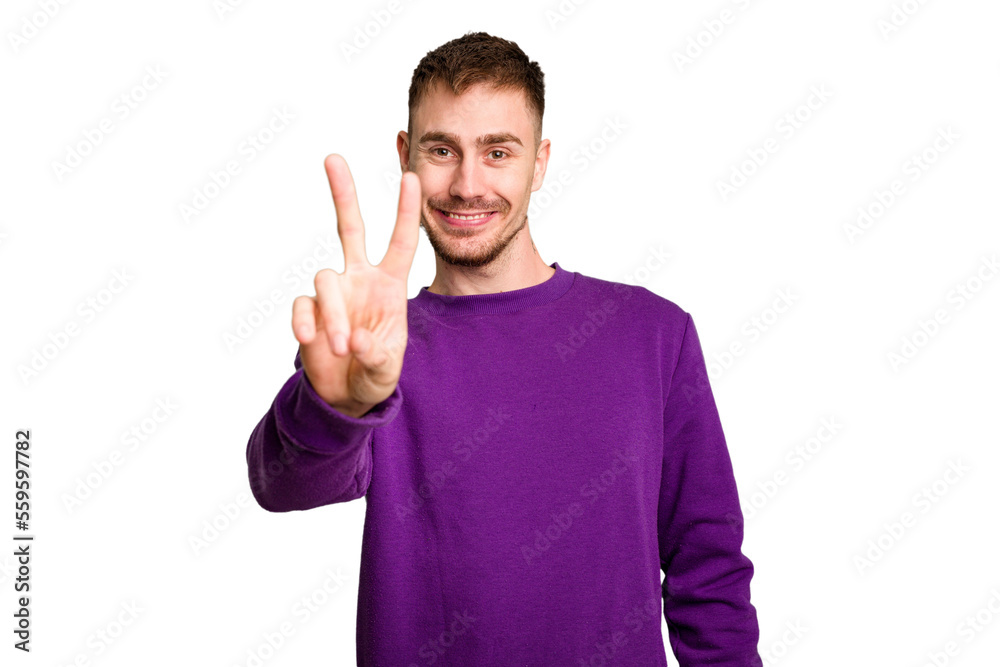 Young caucasian man cut out isolated joyful and carefree showing a peace symbol with fingers. Young caucasian man cut out isolated joyful and carefree showing a peace symbol with fingers.