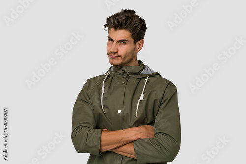 Young handsome caucasian man isolated on white background unhappy looking in camera with sarcastic expression.