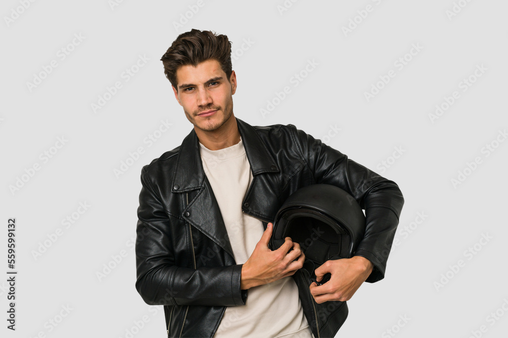 Young caucasian man holding a helmet isolated Young caucasian man holding a helmet isolated