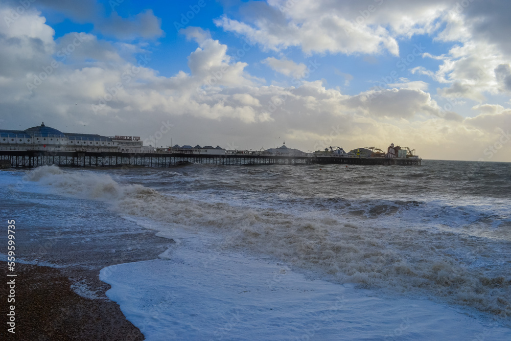 UK, Brighton, 08.01.2022: view of the sea and the main attraction of the city - Brighton Pier Verrennaya weather with high waves