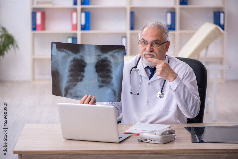Old male doctor radiologist working in the clinic Old male doctor radiologist working in the clinic