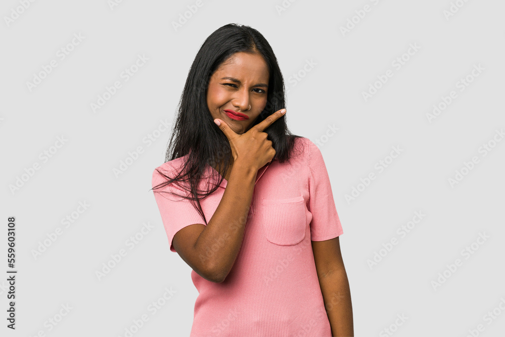 Young Indian woman cut out isolated on white background contemplating, planning a strategy, thinking about the way of a business. Young Indian woman cut out isolated on white background contemplating, planning a strategy, thinking about the way of a business.