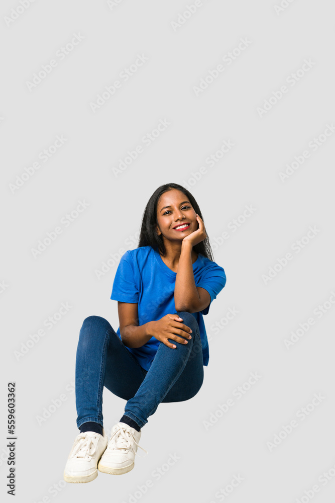 Young Indian woman sitting on the floor isolated on white background Young Indian woman sitting on the floor isolated on white background