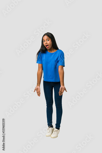 Young Indian woman standing isolated on white background