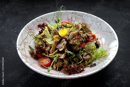 Pickled mushrooms on a plate with lettuce and tomatoes