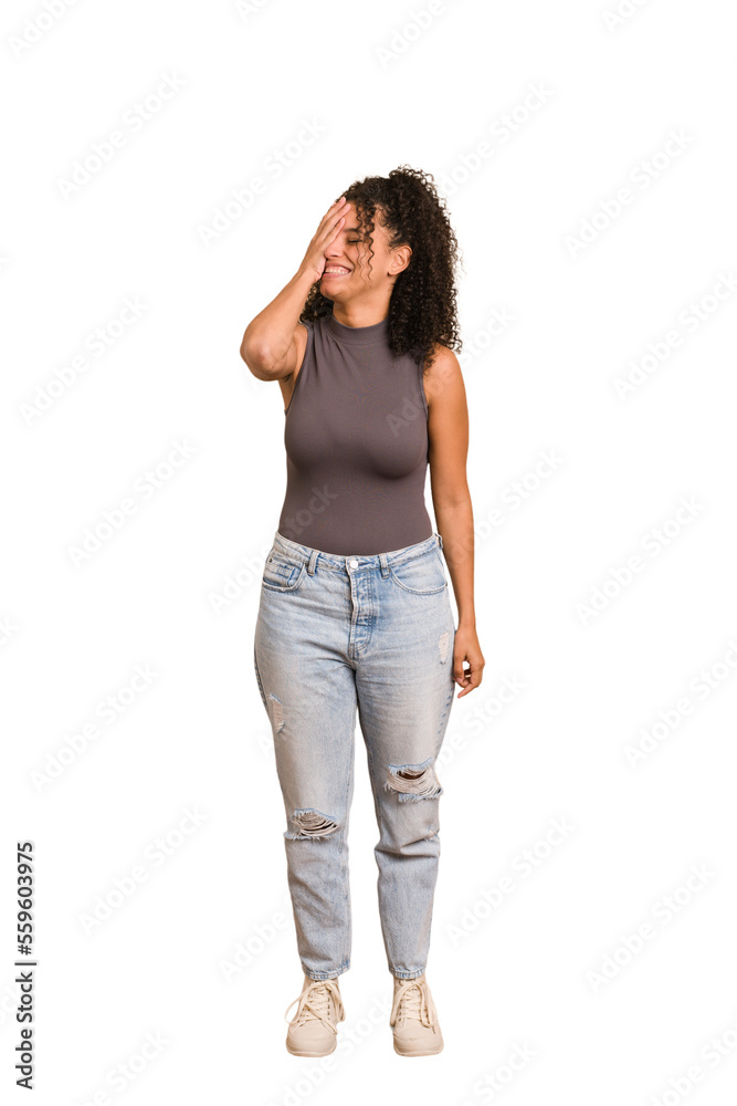 Fototapeta premium Young african american woman with curly hair cut out isolated laughing happy, carefree, natural emotion.