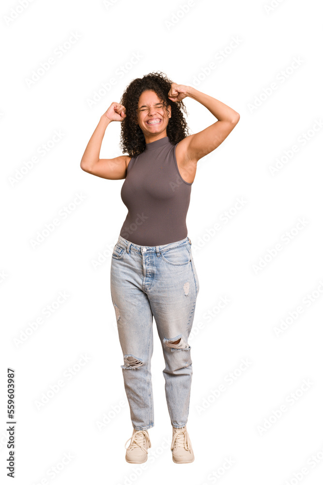 Young african american woman with curly hair cut out isolated raising fist after a victory, winner concept. Young african american woman with curly hair cut out isolated raising fist after a victory, winner concept.