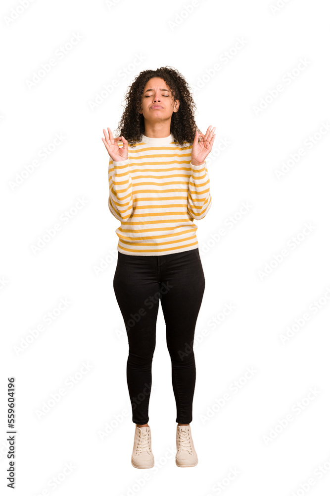 Young african american woman with curly hair cut out isolated relaxes after hard working day, she is performing yoga. Young african american woman with curly hair cut out isolated relaxes after hard working day, she is performing yoga.