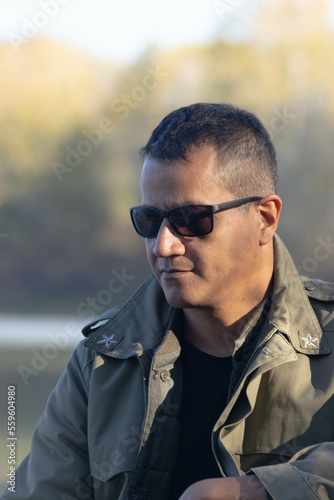 Portrait of military man at lake in autumn