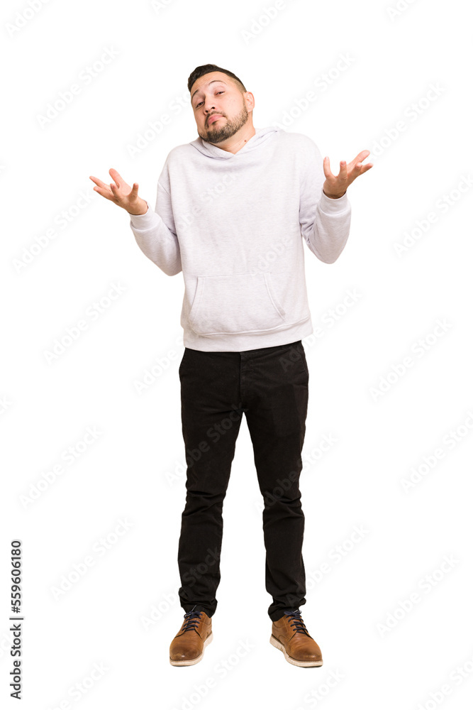 Full body adult latin man cut out isolated doubting and shrugging shoulders in questioning gesture. Full body adult latin man cut out isolated doubting and shrugging shoulders in questioning gesture.