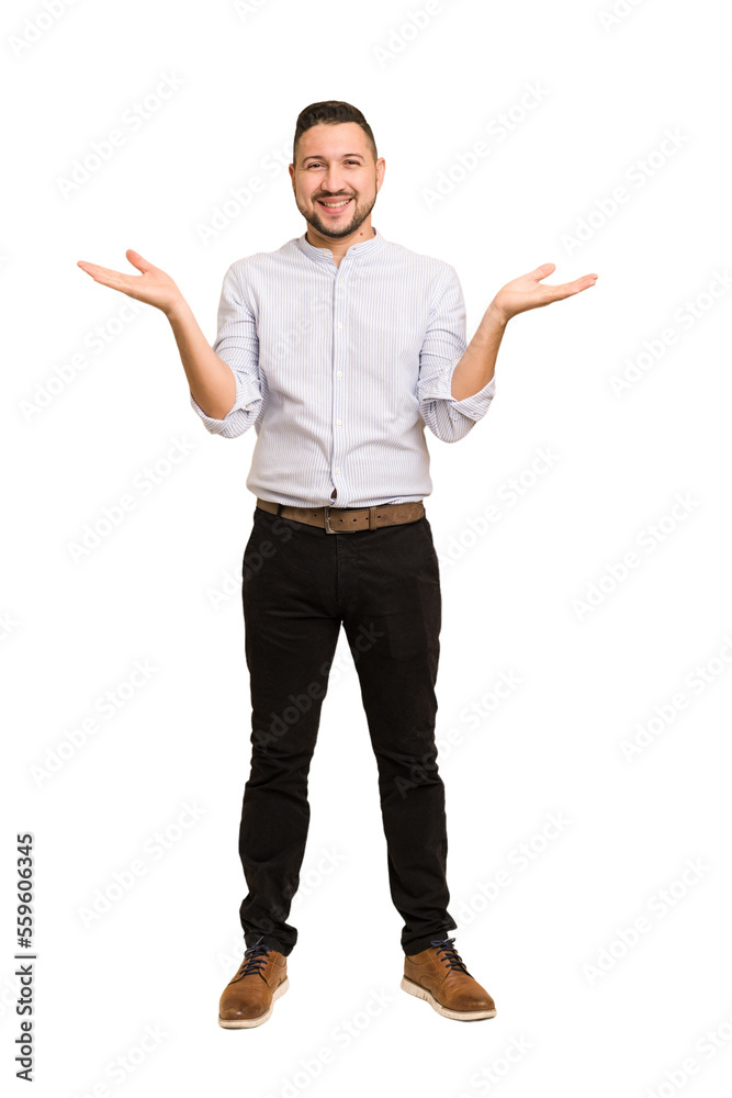 Full body adult latin man cut out isolated makes scale with arms, feels happy and confident. Full body adult latin man cut out isolated makes scale with arms, feels happy and confident.