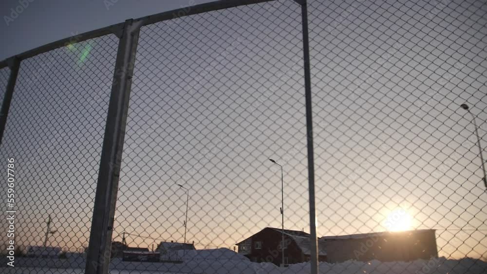 A close-up shot of a hockey goal on a winter background on the street. A close-up shot of a hockey goal on a winter background on the street.