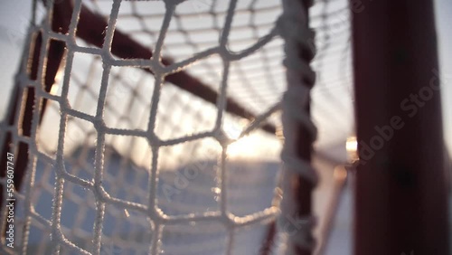 A close-up shot of a hockey goal on a winter background on the street.