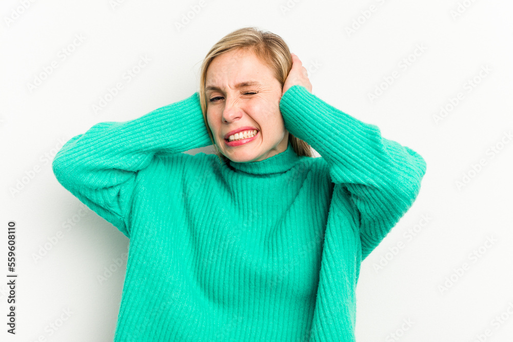 Young caucasian woman isolated on white background covering ears with hands. Young caucasian woman isolated on white background covering ears with hands.