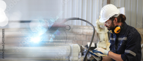 engineer teaching robot welding machine