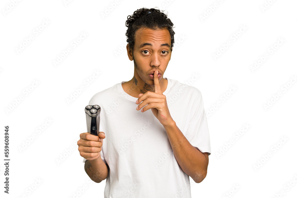 Young African American man holding a razor isolated keeping a secret or asking for silence. Young African American man holding a razor isolated keeping a secret or asking for silence.