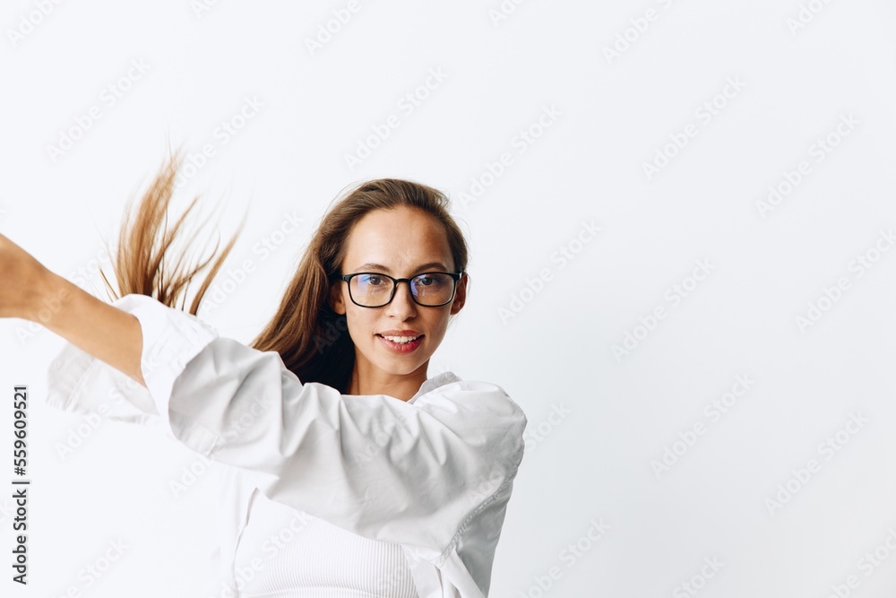 Woman portrait with tanned skin and long natural flowing hair posing on a white background wearing eyeglasses Woman portrait with tanned skin and long natural flowing hair posing on a white background wearing eyeglasses