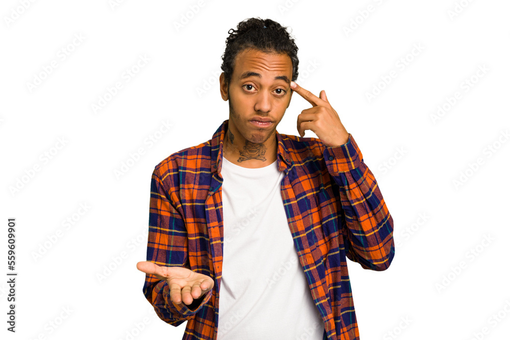 Young African American man isolated holding and showing a product on hand. Young African American man isolated holding and showing a product on hand.