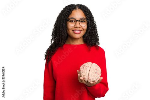 Young african american woman holding a brain model isolated happy, smiling and cheerful.
