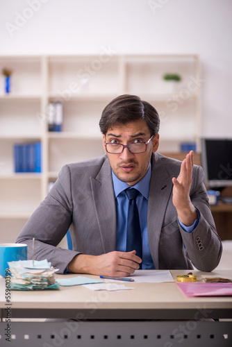 Young male accountant working in the office