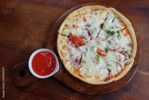 Pizza on a wooden plate